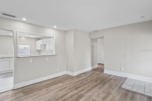 unfurnished living room with light hardwood / wood-style flooring