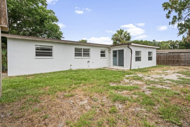 back of property featuring a yard