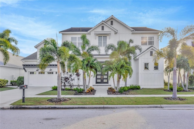 view of front of home with a garage and a front yard