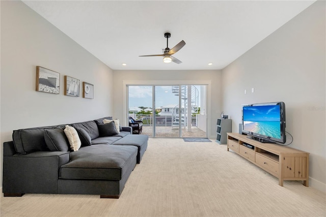 carpeted living room featuring ceiling fan