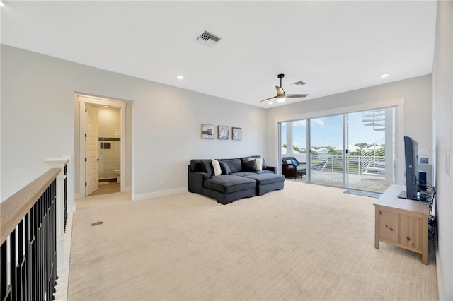 living room featuring ceiling fan and light carpet