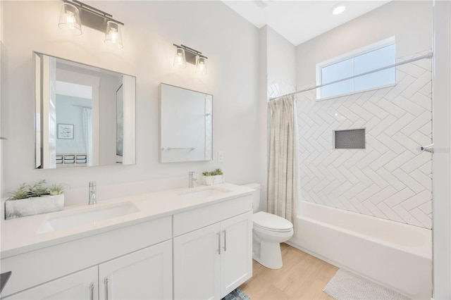 full bathroom featuring toilet, hardwood / wood-style floors, vanity, and shower / bath combo with shower curtain