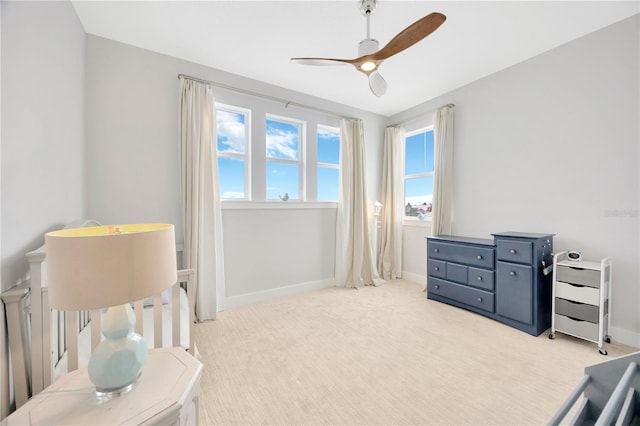 bedroom featuring light colored carpet and ceiling fan