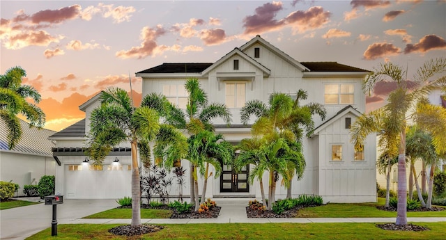 view of front of house featuring a garage and a yard