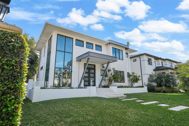 view of front of home featuring a front lawn and stucco siding