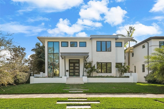 view of front facade with french doors, a front lawn, and stucco siding