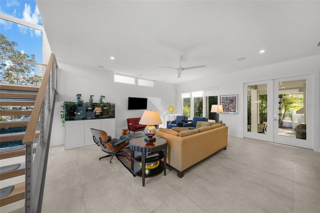 living room featuring ceiling fan and french doors