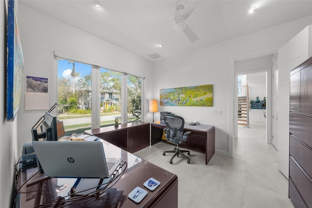 office space with baseboards and a ceiling fan