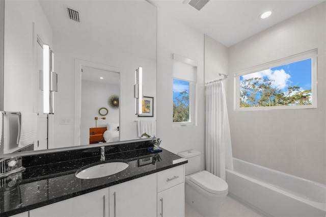 bathroom with toilet, vanity, shower / bath combination with curtain, and visible vents