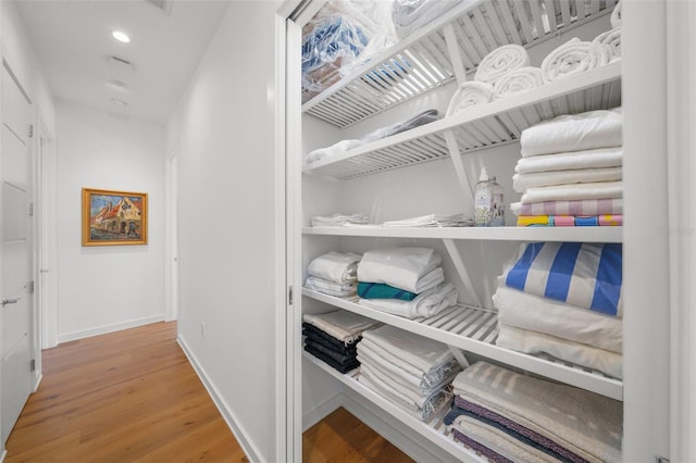 spacious closet featuring hardwood / wood-style flooring