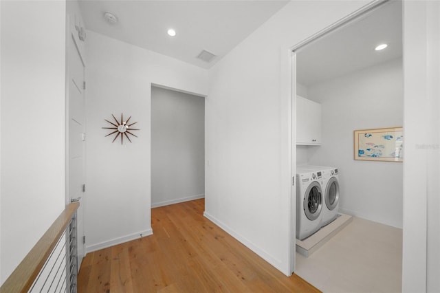 washroom with recessed lighting, visible vents, cabinet space, light wood-style flooring, and separate washer and dryer