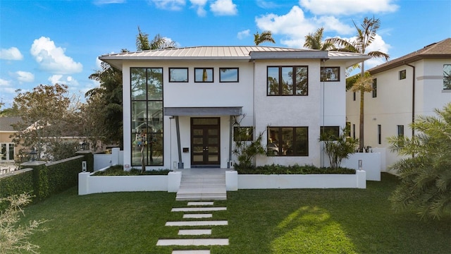 contemporary house with french doors and a front lawn