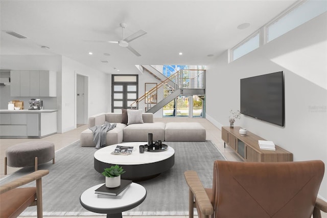 living area featuring light tile patterned floors, ceiling fan, recessed lighting, and baseboards