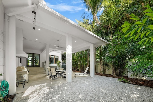 view of patio featuring a grill and fence