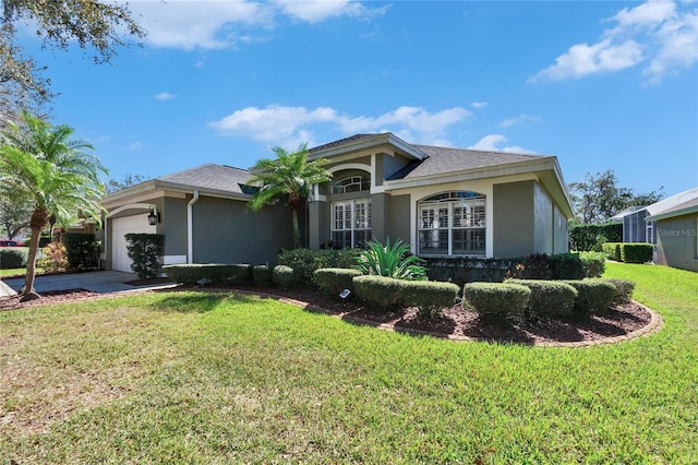 ranch-style home featuring a front lawn and a garage