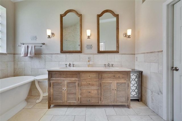 bathroom featuring a tub to relax in, tile walls, and vanity