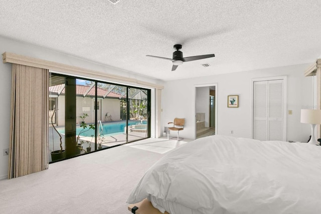 bedroom featuring connected bathroom, carpet, access to outside, ceiling fan, and a textured ceiling