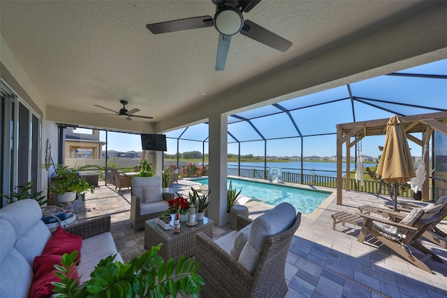 view of patio with ceiling fan, outdoor lounge area, and glass enclosure