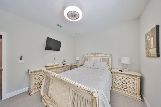 bedroom featuring light colored carpet