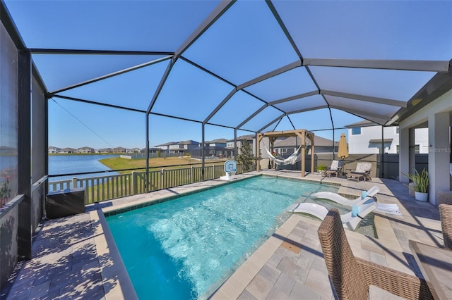 view of pool with a lanai, a patio area, and a water view