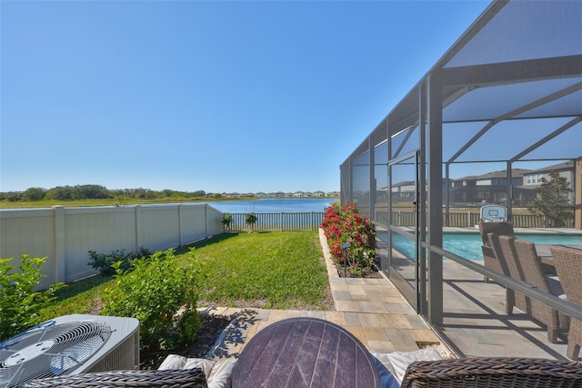 view of yard featuring a fenced in pool, a lanai, a water view, central AC unit, and a patio area