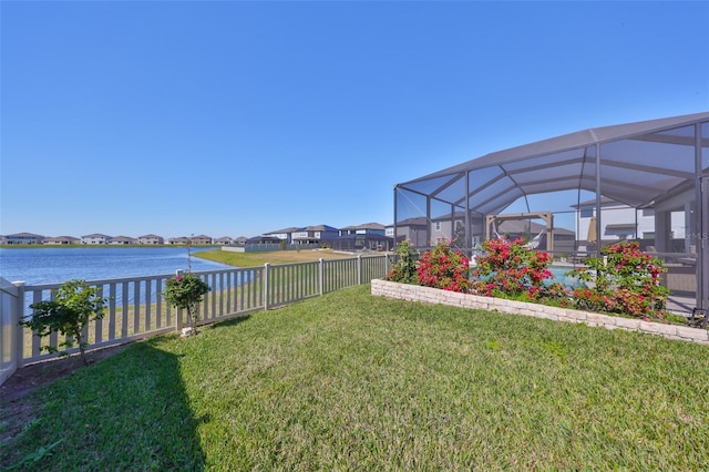 view of yard with a water view and a lanai