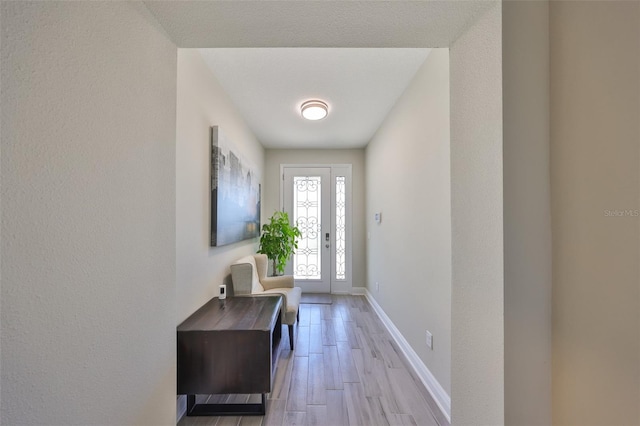 entryway featuring wood finished floors and baseboards