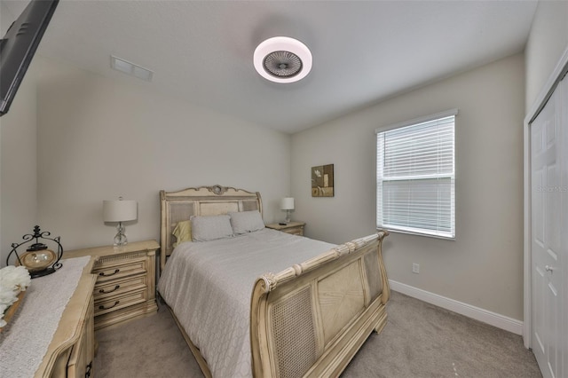 bedroom with carpet floors, visible vents, and baseboards