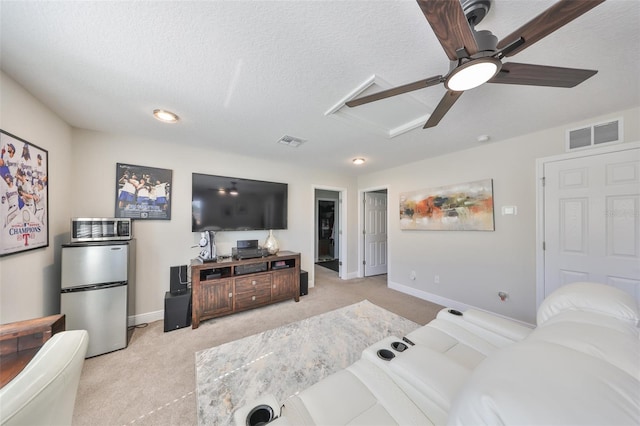 living room with light carpet, baseboards, visible vents, and a textured ceiling