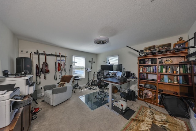 carpeted home office featuring a textured ceiling