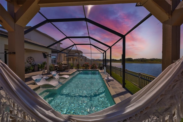 view of swimming pool with a fenced in pool, glass enclosure, and a patio