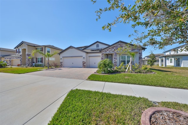 single story home featuring a garage, decorative driveway, roof mounted solar panels, stucco siding, and a front yard