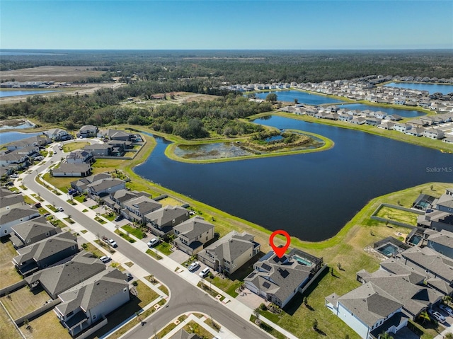 drone / aerial view featuring a water view and a residential view