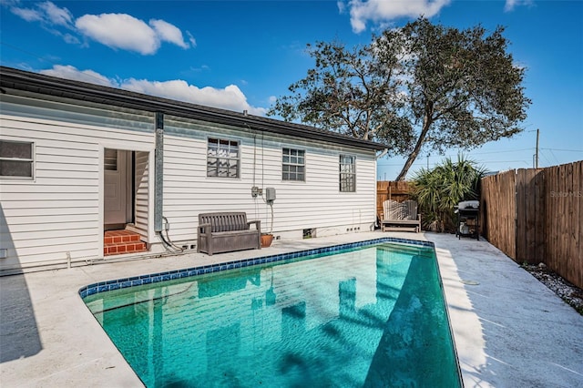 view of swimming pool featuring grilling area