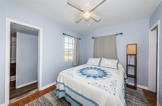 bedroom with ceiling fan and dark hardwood / wood-style flooring