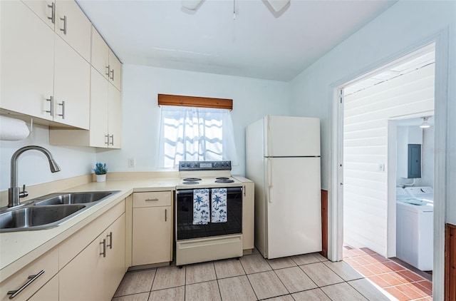 kitchen featuring range with electric cooktop, sink, white refrigerator, electric panel, and washing machine and dryer