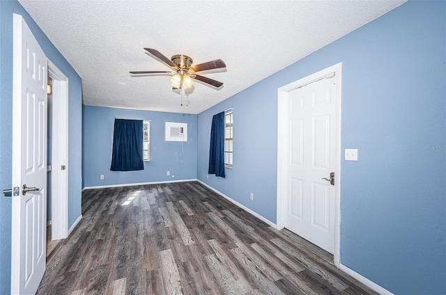 spare room featuring ceiling fan, dark hardwood / wood-style floors, and a textured ceiling