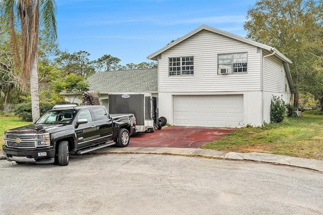 front facade featuring cooling unit and a garage