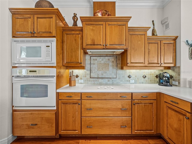 kitchen featuring crown molding, wood-type flooring, white appliances, and decorative backsplash