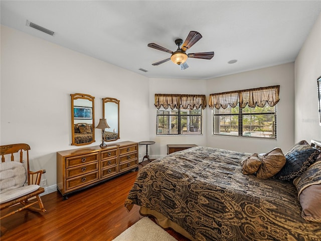 bedroom with dark hardwood / wood-style floors and ceiling fan