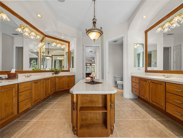 bathroom featuring tile patterned flooring, vanity, and toilet