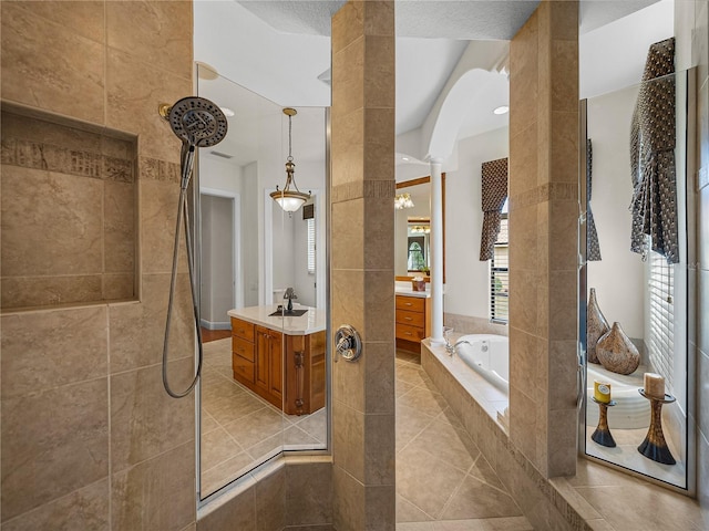 bathroom featuring vanity, tile patterned flooring, decorative columns, and separate shower and tub