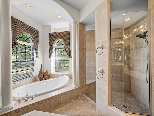 bathroom featuring tile patterned flooring, independent shower and bath, and decorative columns