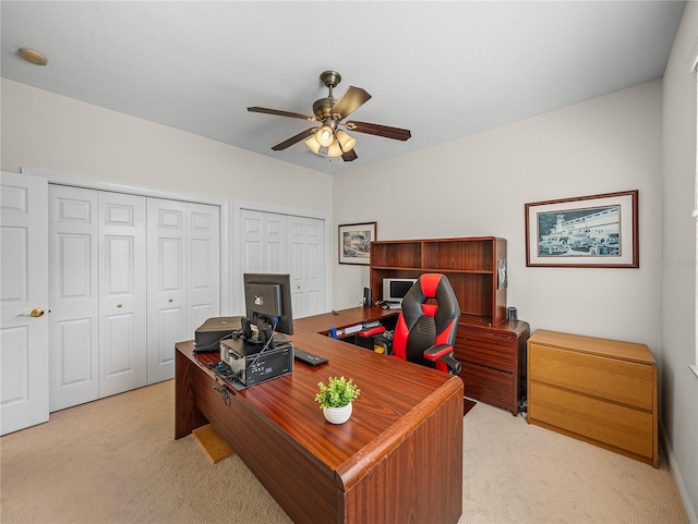 carpeted office with ceiling fan