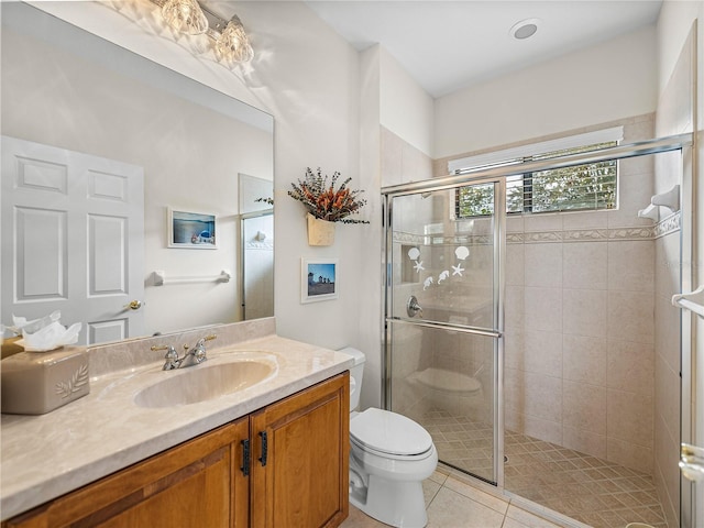 bathroom featuring tile patterned flooring, vanity, walk in shower, and toilet