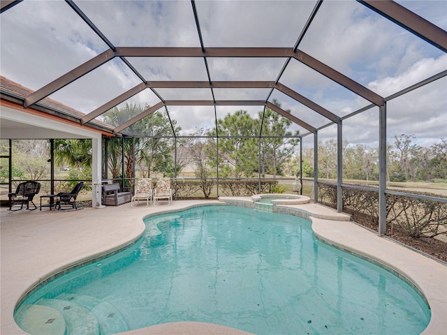 view of swimming pool with an in ground hot tub, a lanai, and a patio