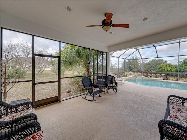 sunroom featuring ceiling fan