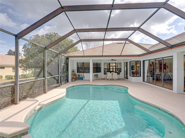 view of pool with a lanai, ceiling fan, and a patio area