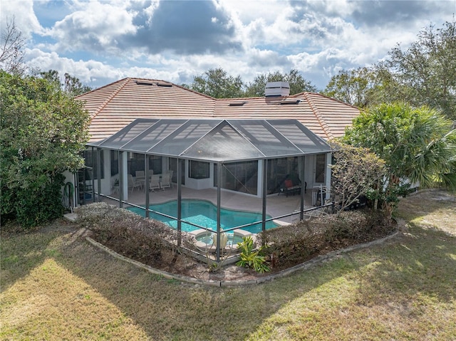 view of swimming pool featuring a yard, a lanai, and a patio