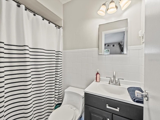 bathroom with a shower with curtain, vanity, tile walls, and toilet